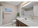 Bathroom featuring modern fixtures, a vanity with ample storage, and a decorative mirror at 609 Chivalry Dr, Durham, NC 27703
