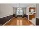 Elegant dining room with hardwood floors, chandelier lighting, and convenient access to the kitchen at 609 Chivalry Dr, Durham, NC 27703