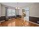 Bright dining room featuring hardwood floors and large window, adjacent to the well-appointed kitchen at 609 Chivalry Dr, Durham, NC 27703