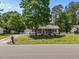 Charming single-story home with a screened front porch, detached garage, and mature trees enhancing the curb appeal at 609 Chivalry Dr, Durham, NC 27703