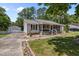 Charming single-story home featuring a screened-in front porch and a detached garage, enhanced by meticulous landscaping at 609 Chivalry Dr, Durham, NC 27703