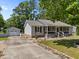 Single-story home with detached garage, landscaping. Serene and private setting near mature trees at 609 Chivalry Dr, Durham, NC 27703