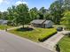 Charming home with a well-manicured lawn, mature trees, and a welcoming front porch at 609 Chivalry Dr, Durham, NC 27703