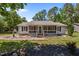 Inviting single-story home boasting a screened front porch, black shutters, and a well-maintained lawn at 609 Chivalry Dr, Durham, NC 27703