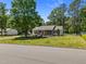Attractive single-story home with a screened front porch, surrounded by mature trees on a neatly kept lawn at 609 Chivalry Dr, Durham, NC 27703