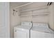 Functional laundry area with washer, dryer, and shelving for storage at 609 Chivalry Dr, Durham, NC 27703