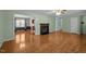 Open-concept living room with hardwood floors, fireplace, and views into dining room and kitchen at 609 Chivalry Dr, Durham, NC 27703