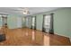 Spacious living room with hardwood floors, neutral walls, and ample natural light from the large windows at 609 Chivalry Dr, Durham, NC 27703