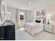 Charming bedroom with pink accents, soft carpet, and a cozy bed dressed in pastel bedding at 701 Deschutes Dr, Garner, NC 27529