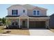 Charming two-story home with a covered entryway and spacious two-car garage at 701 Deschutes Dr, Garner, NC 27529