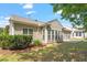 Charming backyard with green lawn, mature bushes, and a bright exterior with plenty of windows at 716 Arbor Brook Dr, Cary, NC 27519
