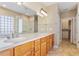 Bathroom featuring a double vanity, a glass-enclosed shower, and access to the walk-in closet at 716 Arbor Brook Dr, Cary, NC 27519