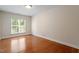 Bedroom with hardwood floors, a large window, and neutral walls at 716 Arbor Brook Dr, Cary, NC 27519