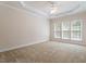 Spacious bedroom featuring plush carpeting, neutral walls, and crown molding at 716 Arbor Brook Dr, Cary, NC 27519