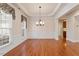Spacious dining room features elegant molding, a classic chandelier, and hardwood floors, creating a perfect space for entertaining at 716 Arbor Brook Dr, Cary, NC 27519