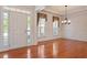 Bright foyer with hardwood floors, decorative molding, and a chandelier, showcasing the home's elegant architectural details at 716 Arbor Brook Dr, Cary, NC 27519