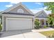 Inviting home exterior showcasing a two-car garage, manicured landscaping, and neutral siding at 716 Arbor Brook Dr, Cary, NC 27519