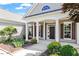 Close-up of the front porch with elegant columns, a well-maintained garden, and a welcoming entranceway at 716 Arbor Brook Dr, Cary, NC 27519