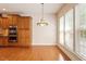 Eat-in kitchen featuring stainless appliances, hardwood floors, and ample sunlight at 716 Arbor Brook Dr, Cary, NC 27519