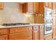 Chef's kitchen featuring a gas cooktop, granite counters, and stainless steel appliances at 716 Arbor Brook Dr, Cary, NC 27519