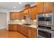 Well-equipped kitchen featuring custom cabinets, granite countertops, and stainless steel appliances at 716 Arbor Brook Dr, Cary, NC 27519
