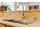 Close-up of a kitchen sink with a stainless steel faucet and granite countertop at 716 Arbor Brook Dr, Cary, NC 27519