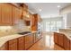 Gourmet kitchen with granite countertops, stainless steel appliances, and custom cabinetry at 716 Arbor Brook Dr, Cary, NC 27519