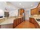 Open kitchen with granite countertops, stainless steel appliances, and hardwood floors at 716 Arbor Brook Dr, Cary, NC 27519