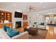 Inviting living room featuring a cozy fireplace, custom built-ins, and comfortable seating, perfect for relaxation and gatherings at 716 Arbor Brook Dr, Cary, NC 27519
