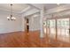 Open floor plan featuring hardwood floors, decorative molding, and a view into the kitchen and other living spaces at 716 Arbor Brook Dr, Cary, NC 27519
