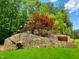 Shinleaf Estates entrance with stone wall, trees, and landscape art detail in a tranquil setting at 7652 Falls Creek Ln, Raleigh, NC 27614