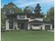 Beautiful two-story house featuring stone accents and large windows, ideal for natural light at 7652 Falls Creek Ln, Raleigh, NC 27614