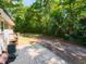 Backyard features a brick patio and wooded area, perfect for outdoor entertaining at 801 Madison Ave, Cary, NC 27513