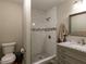 Updated bathroom features a tiled shower and vanity with marble countertop at 801 Madison Ave, Cary, NC 27513