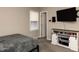Modern bedroom equipped with TV and entertainment center, enhanced by natural lighting at 801 Madison Ave, Cary, NC 27513