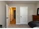 Bedroom with hardwood floors visible from doorway and neutral-colored carpet, plus natural light at 801 Madison Ave, Cary, NC 27513