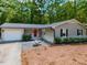 Charming single-story home with a red front door, gray siding, and well-maintained landscaping at 801 Madison Ave, Cary, NC 27513