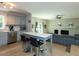 Modern kitchen with stainless steel appliances, gray cabinets, and a breakfast bar that seats two at 801 Madison Ave, Cary, NC 27513