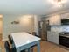 Modern kitchen with stainless steel appliances, gray cabinets, and a breakfast bar that seats four at 801 Madison Ave, Cary, NC 27513