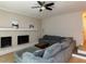 Spacious living room featuring a brick fireplace, ceiling fan, and comfortable gray sectional sofa at 801 Madison Ave, Cary, NC 27513