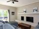 Comfortable living room featuring a painted brick fireplace, and sliding glass doors to the patio at 801 Madison Ave, Cary, NC 27513