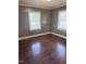 Cozy bedroom featuring wood floors and windows providing ample natural light at 808 Belvedere St, Rocky Mount, NC 27803