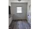 Cozy dining nook with grey wood flooring, bright window, and white door at 808 Belvedere St, Rocky Mount, NC 27803