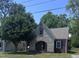 Charming stone and brick home with mature tree, arched entry, and well-maintained lawn at 808 Belvedere St, Rocky Mount, NC 27803