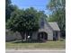 Charming stone and brick home with mature tree, arched entry, and well-maintained lawn at 808 Belvedere St, Rocky Mount, NC 27803