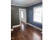 Living room with hardwood floors, classic trim, and view into dining area at 808 Belvedere St, Rocky Mount, NC 27803