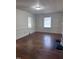 Bright living room featuring hardwood floors and classic trim with view of windows at 808 Belvedere St, Rocky Mount, NC 27803