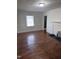 Living room with hardwood floors, classic trim, and view into hallway at 808 Belvedere St, Rocky Mount, NC 27803