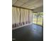 Enclosed sunroom featuring concrete floors and an open backyard view at 808 Belvedere St, Rocky Mount, NC 27803