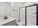 Bathroom with sleek black-framed glass shower and vanity with solid surface countertop at 808 Hillfarm Dr, Wake Forest, NC 27587